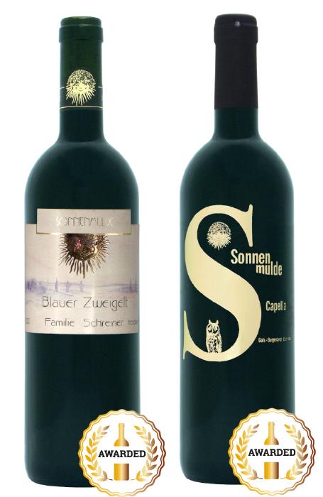 Close-up of one bottle each of Blauer Zweigelt 2002 and Capella 2012 with and award seal.
